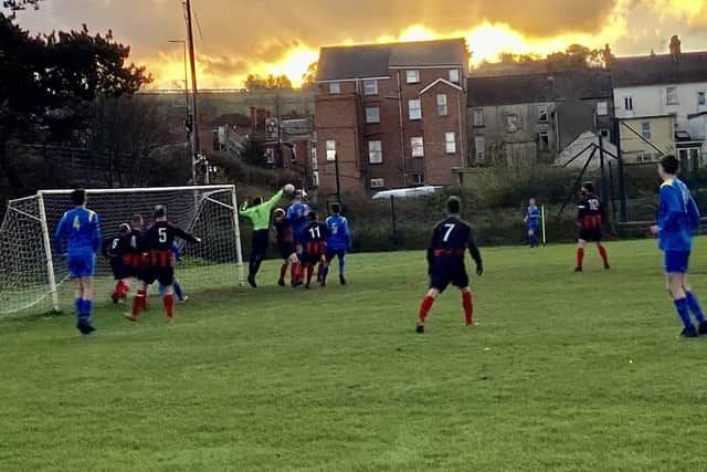 Carryduff's skipper Rory McDonnell puts the Whitehead ‘keeper under pressure
