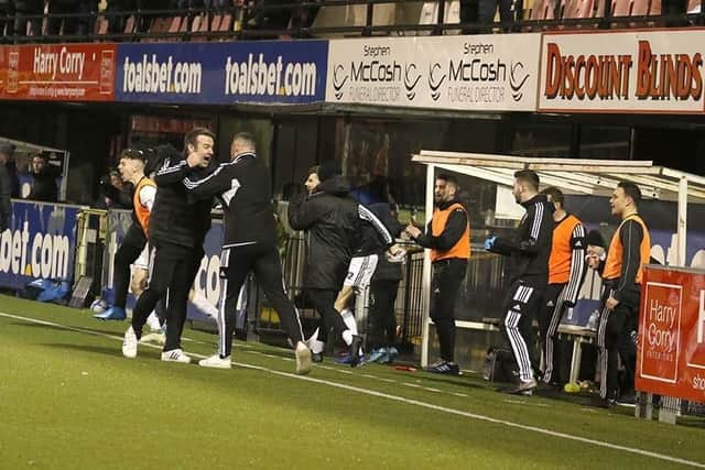 The Rathfriland bench celebrate at the final whistle.