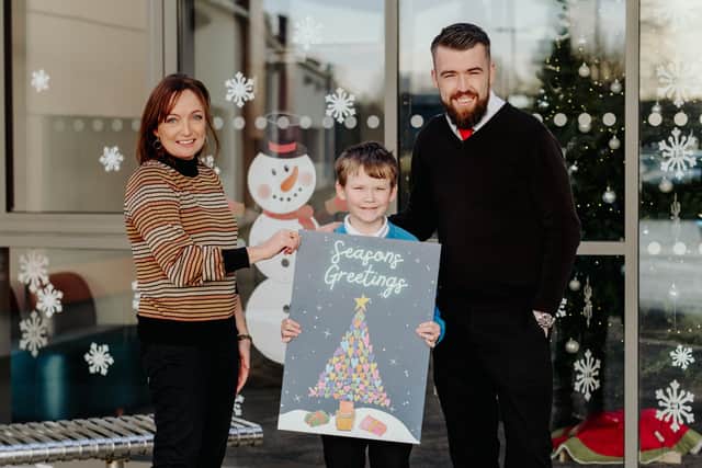 Bringing Festive Cheer: Melanie Rintoul, Radius, Housing, with Christmas Card Competition winner Adrian McVeigh, and his teacher John McAllister.