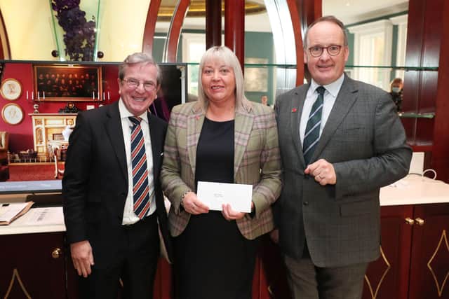 Norma Craig with Howard Hastings, managing director and  James McGinn, director.