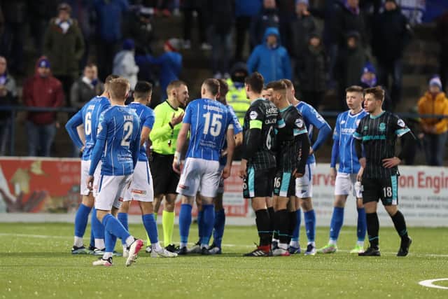Coleraine players remonstrate with referee Tim Marshall after Stephen Fallon's goal