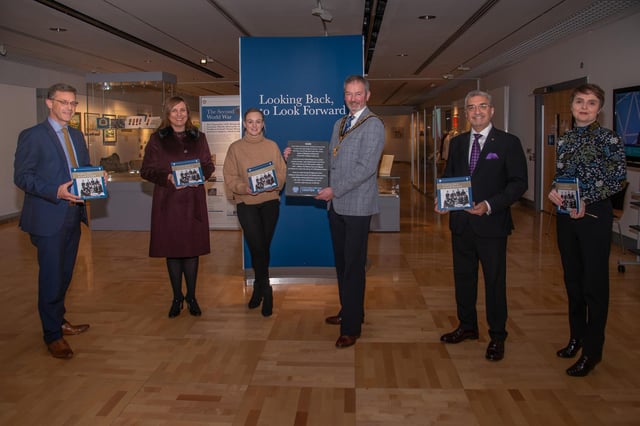 Pictured is Mayor of Mid and East Antrim, Cllr William McCaughey with Philip Thompson, Acting Chief Executive; Angeline King, who created the poem ‘Home’ as part of the project’s creative initiative and inscribed on the stone tablet featured; Councillor Cheryl Brownlee, Chair of Council’s NI Centenary Working Group; Mukesh Sharma, Chair, National Lottery Heritage Fund Northern Ireland Committee and Jayne Clarke, Museum and Heritage Manager.