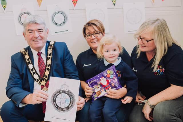 Mayor, Cllr Billy Webb with staff from Ballyduff Kids' Club and the winner of the colouring competition.