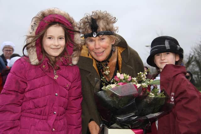 Baroness Hoey received a bouquet of flowers from Lydia and Anna Thompson.