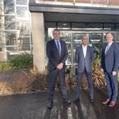 Wrightbus MD, Neil Collins, Wrightbus CEO, Buta Atwal, and First
Minister Paul Givan outside the Wrightbus factory in Ballymena.