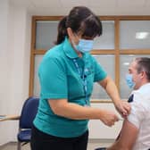 The First Minister received his booster jab from vaccinator Moira Mulholland during the visit. Photo by Jonathan Porter / Press Eye.