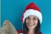 Joanne Cochrane holds up her Christmas sandbag stocking to raise awareness of the hunger crisis in flood-hit South Sudan.