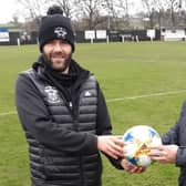 Former Rathfriland player Stephen McAlinden presents a match ball to chairman Adrian Megaw