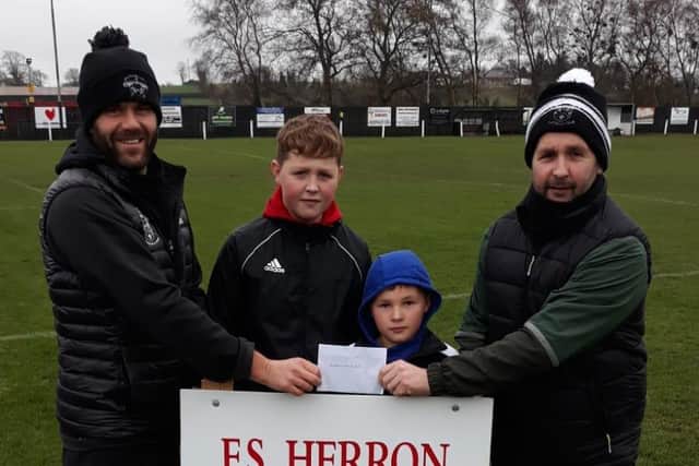 Andrew Smyth presents match sponsorship cheque to Adrian Megaw on behalf of F S Herron. Also pictured are youth players Charlie and Archie Smyth