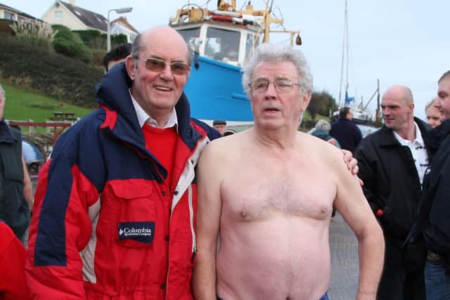 The temperature was a balmy 10 degrees for the New Years Day Spina Bifida swim in Carnlough, one of the warmest in the swim’s thirty-six year history as reflected by one of the swim’s veterans John ‘Smudger’ Smith. However event organiser Billy McIlroy was taking no chances as he wore his winter clothes. BT2-118JC