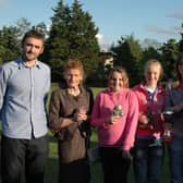 GIRL POWER.. Alan and Ruby Peacock pictured with Amy Gibson ( Most Improved Player), Lauren Wade (Players' Player of the Year) and Zoe Campbell ( Player of the Year) from the Bertie Peacock Youths girls team. Also included in the photograph is Reeves Doherty from West Bann Coleraine Supporters Club. Cr22-321(s)