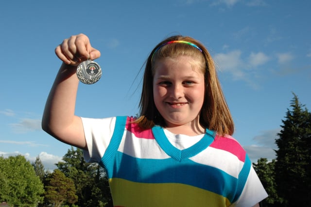 PROUD AS A PEACOCK....Molly Henderson shows off her medal at the Bertie Peacock Youths awards night held at Killowen Primary School last Friday. Cr22-324(s)