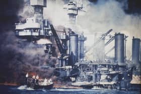 Photograph showing a small boat rescuing a USS West Virginia crew member from the water after the Japanese bombing of Pearl Harbor, Hawaii on December 7, 1941. Picture: US Navy via AP