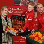 Ben Dickinson is joined by Meabh Austin of FareShare and Larne FC player, John Herron, to launch his 'Miles for Meals’ campaign.