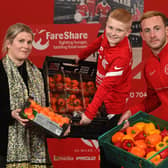 Ben Dickinson is joined by Meabh Austin of FareShare and Larne FC player, John Herron, to launch his 'Miles for Meals’ campaign.