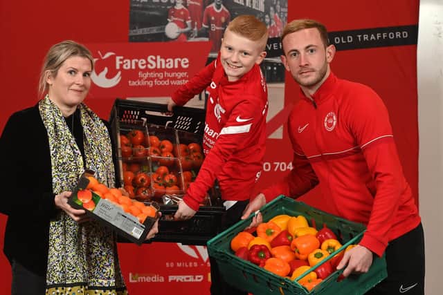 Ben Dickinson is joined by Meabh Austin of FareShare and Larne FC player, John Herron, to launch his 'Miles for Meals’ campaign.