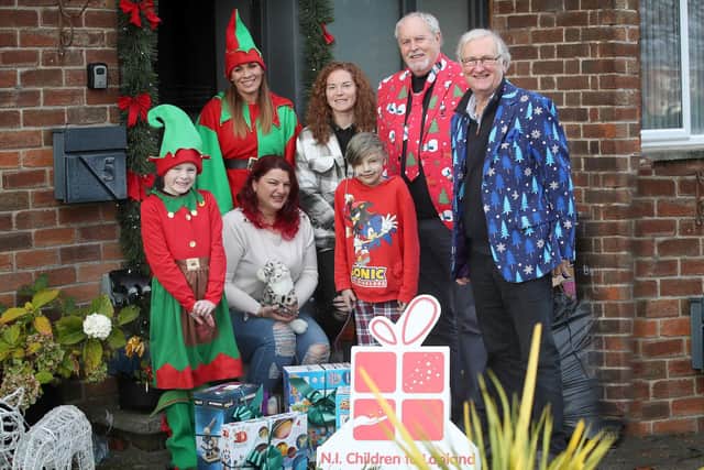 NICLT ‘elf’ Carlie Martin; new NICTL charity ambassador, Northern Ireland Women’s Football Team captain, Marissa Callaghan; NICLT president, television broadcaster, Gerry Kelly; Colin Barkley, chair, NICLT; and front row (l-r) Charlie Martin (charity elf!) making a special delivery to Matti Pospiech and Matti’s mum Joanna.