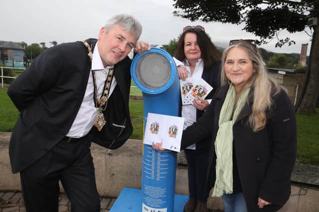 The Mayor of Causeway Coast and Glens Borough Council Councillor Richard Holmes listens to the Poetry Jukebox at Ballycastle seafront with the Desima Connolly from Causeway Coast and Glens Borough Council’s Arts team and Maria McManus from Poetry Ireland