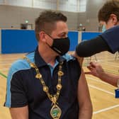 The Mayor, Alderman Graham Warke receives his Covid-19 vaccination booster in the Foyle Arena from Kathleen Crossan who was a district nurse before retiring. Picture Martin McKeown. 15.12.21