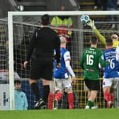 Jay Donnelly heads home an equaliser for 10-man Glentoran at Windsor Park as the 'Big Two' top-of-the-table derby date with Linfield finished honours even in a 1-1 draw. Pic by Pacemaker.