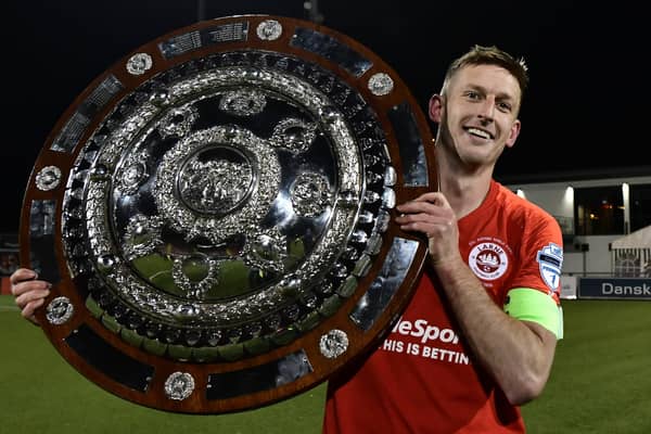 Larne captain Jeff Hughes celebrates winning the Co Antrim shield in 2020. Pic Colm Lenaghan/Pacemaker