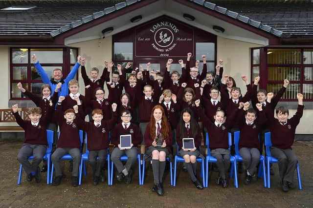 Loanends Primary 7 Class Jumping for joy with P7 teacher Mr Sam Hyde, Principle Mrs Linda Armour and the 10Ticks trophy