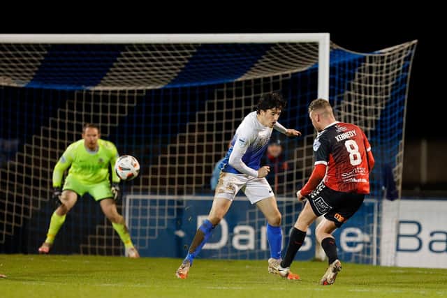 Ben Kennedy curls home a fine strike to increase Crusaders’ advantage over Glenavon. Pic by Pacemaker.