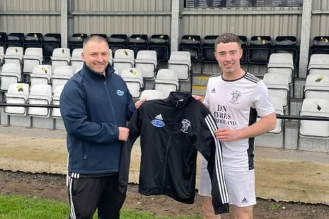 Rathfriland FC member Brian Magennis who is employed by the firm is pictured here presenting the new gear to Rangers Reserves captain John Dickson