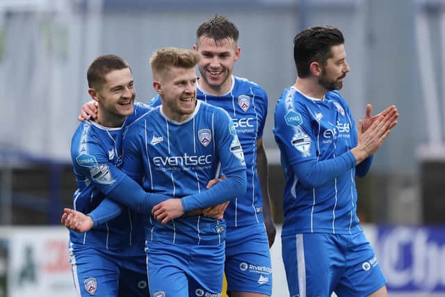 Coleraine players celebrate with Lyndon Kane after his penalty made it 3-0