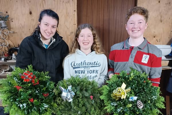 Harry and Molly Lyttle once again raised vital funds for Alzheimer’s Society by creating and selling Christmas Wreaths. They are pictured with Lucy McClintock.