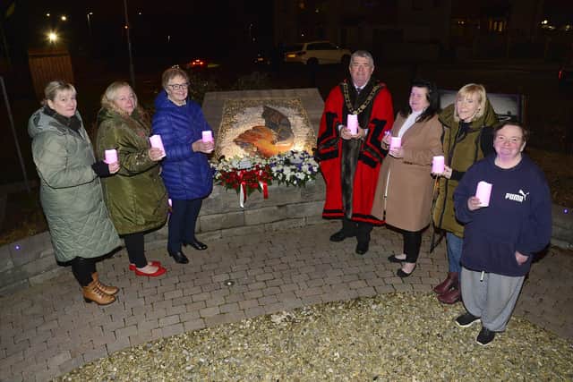 Mayor of Antrim and Newtownabbey Cllr Billy Webb with ladies from the Community Relations Forum who helped make the mosaic for the Holocaust memorial.