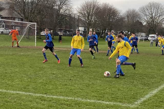 Carryduff Colts' Michael Deeny tries to unlock a packed Rooftop defence