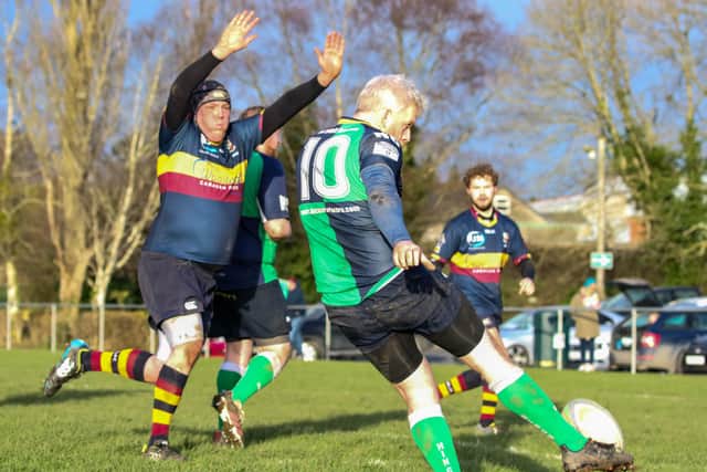 Jonny Martin tries to charge down a Ballynahinch kick. Picture: John Mullan