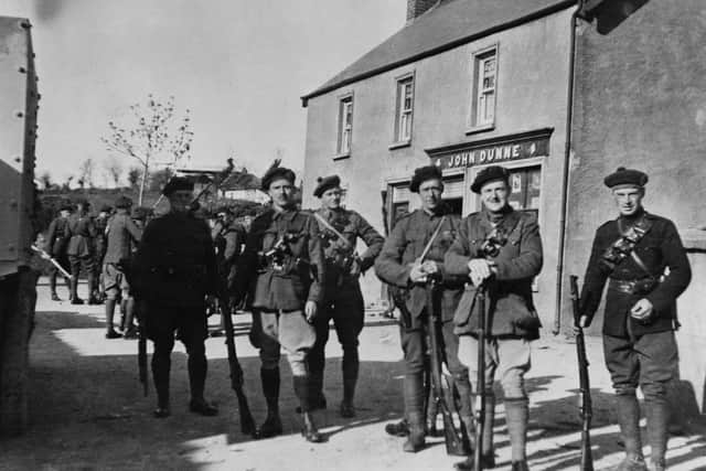 1921:  Black and Tans 'beginning a drive at Dundrum', from the town of Drombane in Tipperary. They are Copley, Blake, Frost, Tanburn, Canfles and Bromfield. John Dunne's shop is behind them.  Original Publication: From the A E Bell Collection.  (Photo by Hulton Archive/Getty Images)