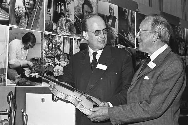 Mr Colin Anderson, chairman of LEDU with Mr John Waddell, former chairman, at the opening of an exhibition to mark the 10th anniversary of the Local Enterprise Development Unit in September 1981. They are seen admiring the work of Mr James McKillop, a violin maker from Carnlough, Co Antrim. Picture: News Letter archives