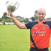 Brigade captain Andy Britton celebrating last season's NW Senior Cup success.