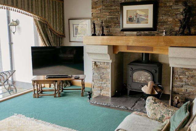 The sitting room has a feature fireplace with wood burner.