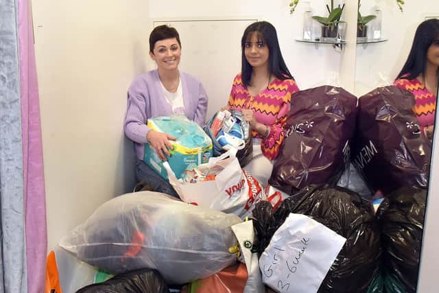 Sitting amongst just a small proportion of the donations to the Sitara Morgan Ukraine Emergency Appeal are, Kaisa Simpson, shop manager, and Kristy Gray, shop owner. INPT09-214.