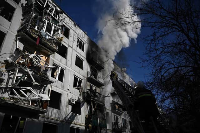 A building is left smoking after bombings on the eastern Ukraine town of Chuguiv.