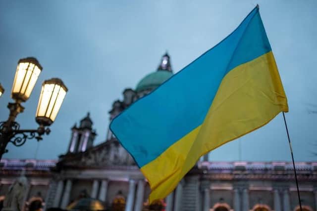 The Ukrainian flag flies during a special vigil at Belfast City Hall last week. Hundreds gathered to protest against the Russian military invasion of Ukraine. Photo: Kirth Ferris/Pacemaker Press