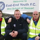 KICK OFF...Kyle McVey, Coleraine FC, who officially opened the East End Youths Smurs mini school of soccer sessions, pictured with John Wright, chairman of East End Youths and Gary Devenney, Smurfs co-ordinator. Cr18-217s