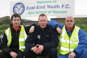 KICK OFF...Kyle McVey, Coleraine FC, who officially opened the East End Youths Smurs mini school of soccer sessions, pictured with John Wright, chairman of East End Youths and Gary Devenney, Smurfs co-ordinator. Cr18-217s