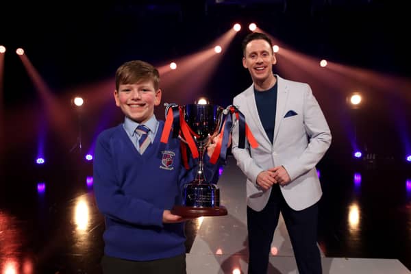 Tom Johnston from Macosquin Primary School with presenter Connor Phillips after Tom received his trophy for winning the Primary final of the BBC Northern Ireland School Soloist Of The Year 2022
