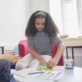 Photography by Tom Hull. The child pictured is a model. The image includes a real-life NSPCC practitioner.