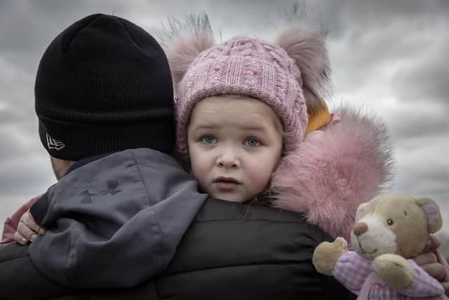 A four-year-old meets her godfather as she crosses the border in Medyka, on the Ukraine-Poland border, on March 2, 2022. Picture: Adrienne Surprenant /MYOP 2022