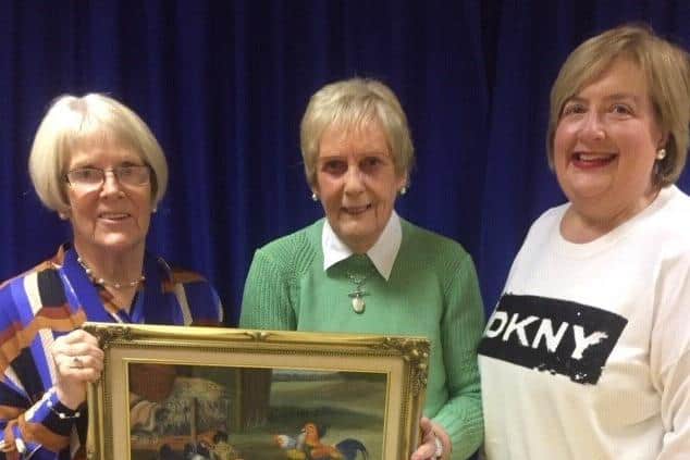 Muckamore WI President Elizabeth Gray and Secretary Sharon Carson with Marjorie Hamilton winner of the monthly competition