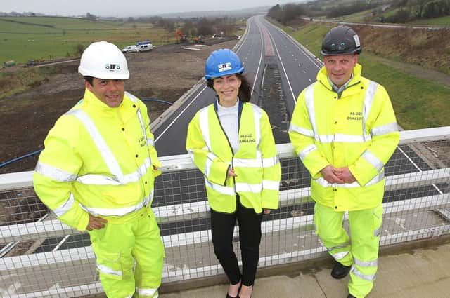 Minister Nichola Mallon is pictured with Juan Rodriguez-Altonaga Martinez (Contracts Manager) and Michael Troughton (Project Director) representing the Contractor Joint Venture of Sacyr, Wills Bros Ltd and Somague.