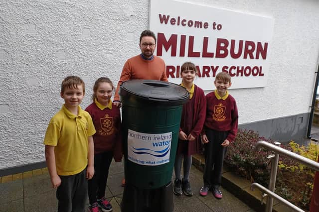 Pictured are Millburn PS  pupils with their new Waterbutt