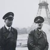 Adolf Hitler standing in front of the Eiffel Tower in Paris during the Second World War