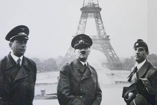 Adolf Hitler standing in front of the Eiffel Tower in Paris during the Second World War